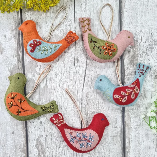 Five felt birds with hand embroidery.